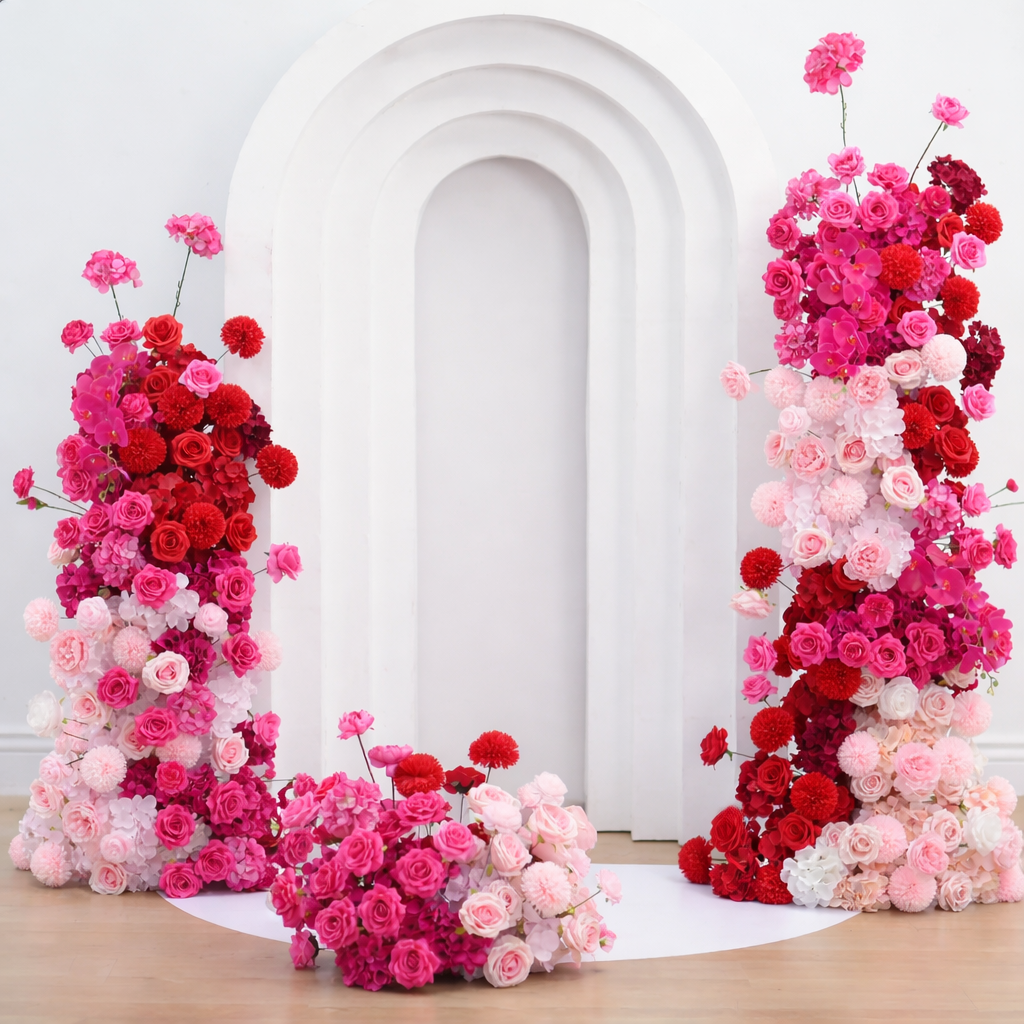 Pink floral arrangement in front of a white backdrop