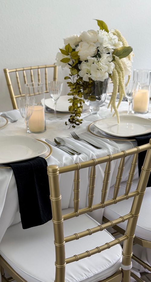 A bridal themed table setting with white florals and candles