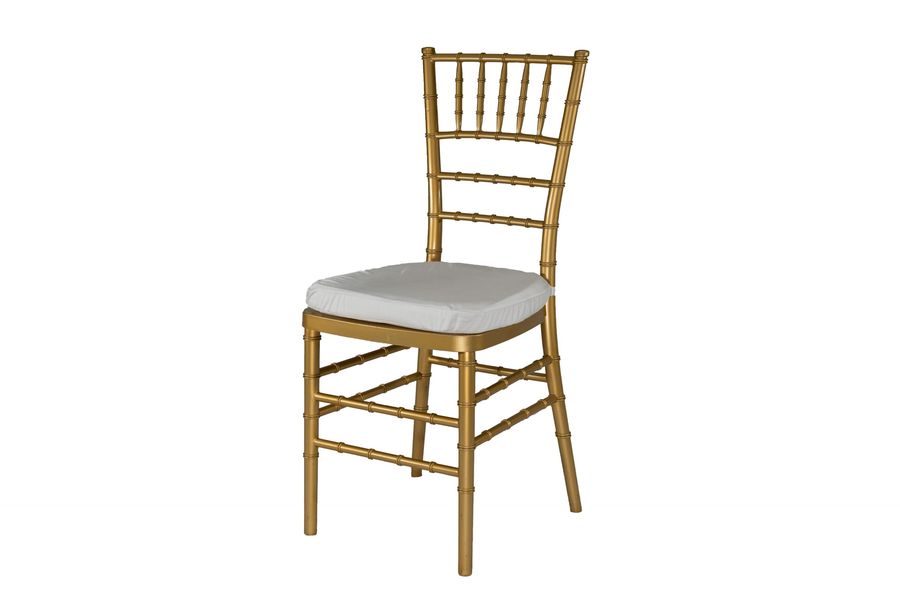 White chiavari chairs around a linen-draped table set for an outdoor reception.