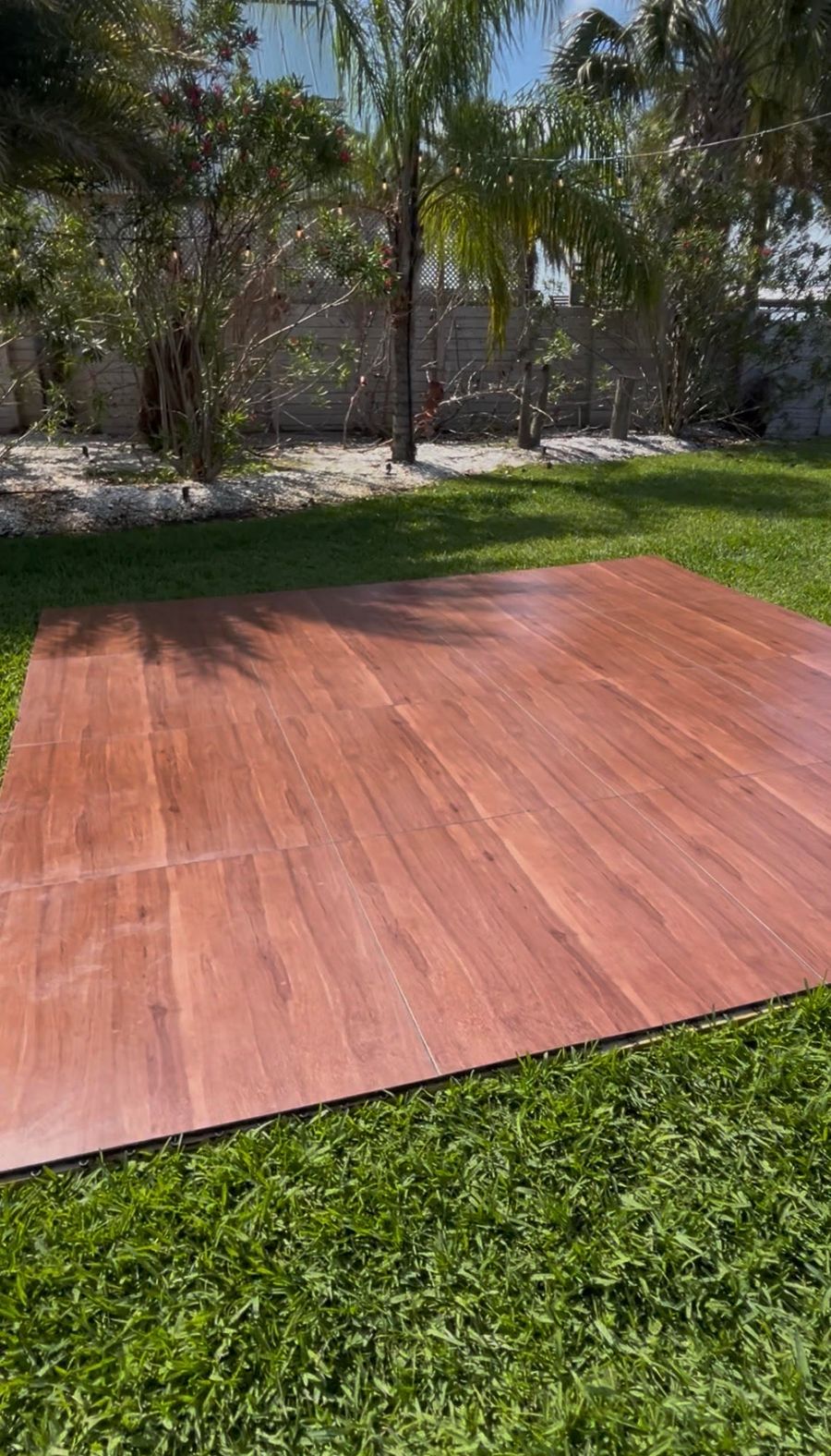 A dark maple dance floor installed at a reception.