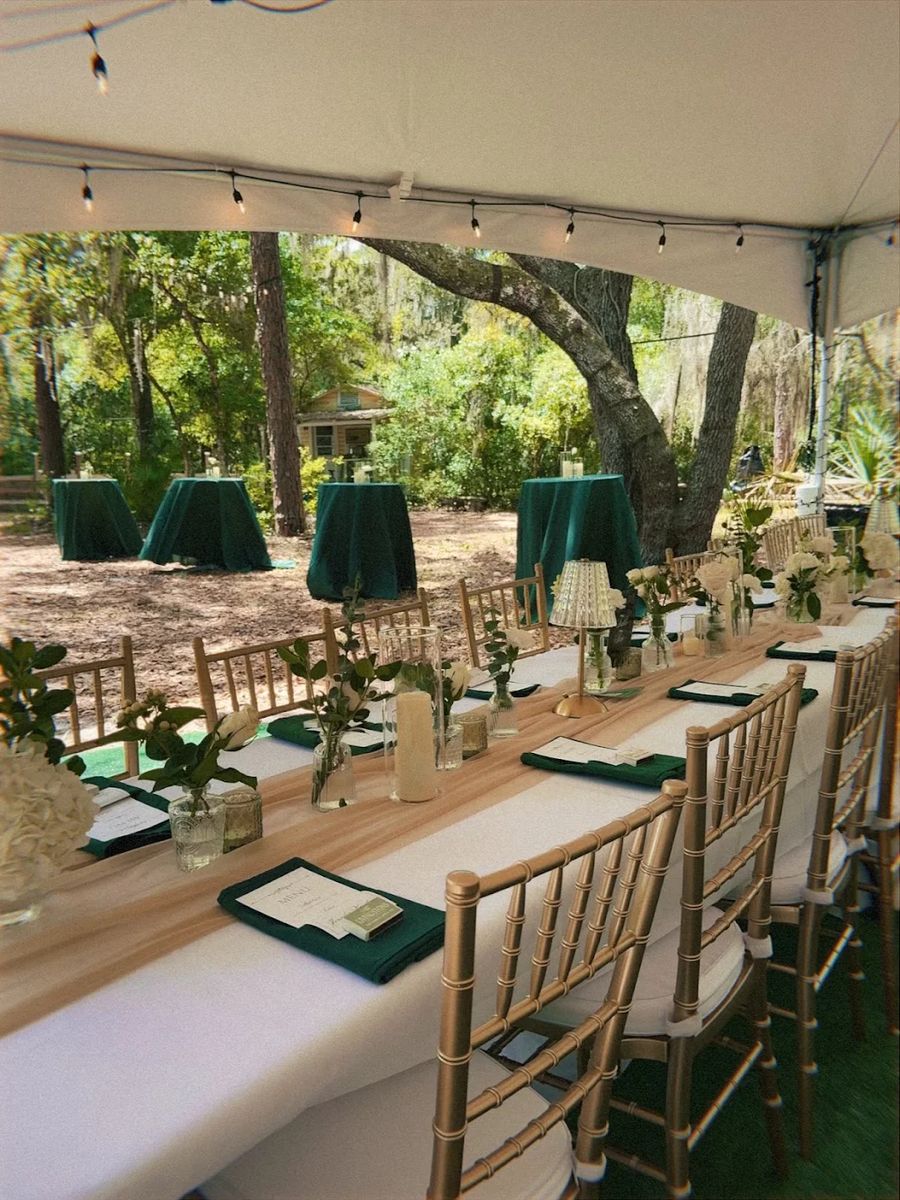 Dark green and white colored tablescape with chiavari chairs